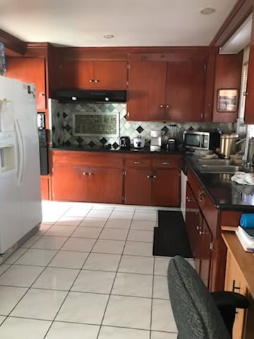 A well-equipped kitchen with wooden cabinets and modern appliances.