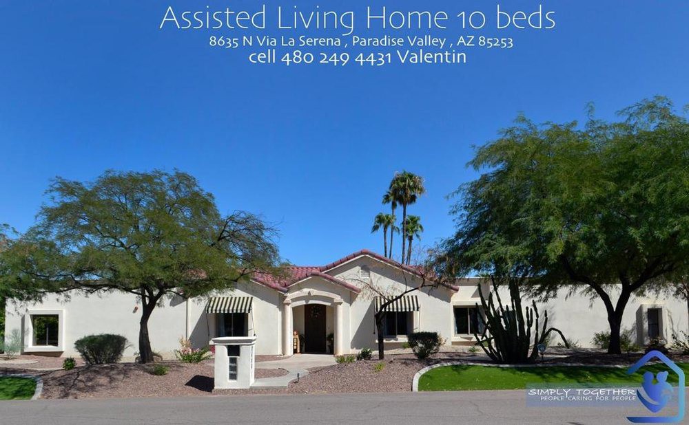 Image of an assisted living facility with palm trees in the background.
