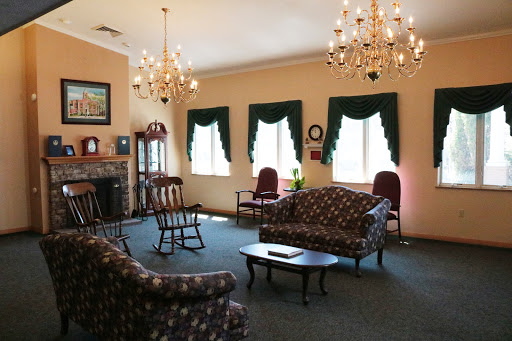 A cozy living room featuring elegant chandeliers and comfortable seating.