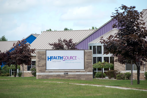 HealthSource medical facility showcasing its sign in a suburban area.