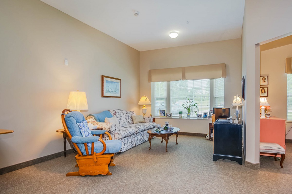A cozy living room with comfortable seating and warm lighting.