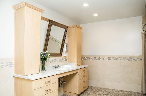 A modern bathroom featuring a sleek vanity with a sink, mirror, and natural elements.