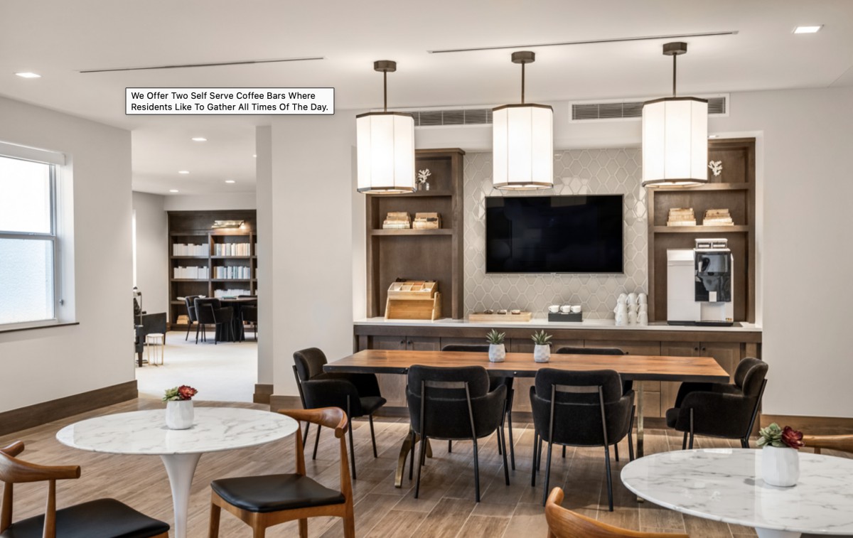 A modern dining area with elegant lighting and wooden furnishings.