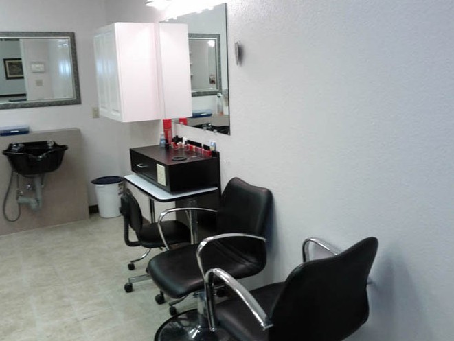 A clean and modern hair salon setup with chairs and mirrors.
