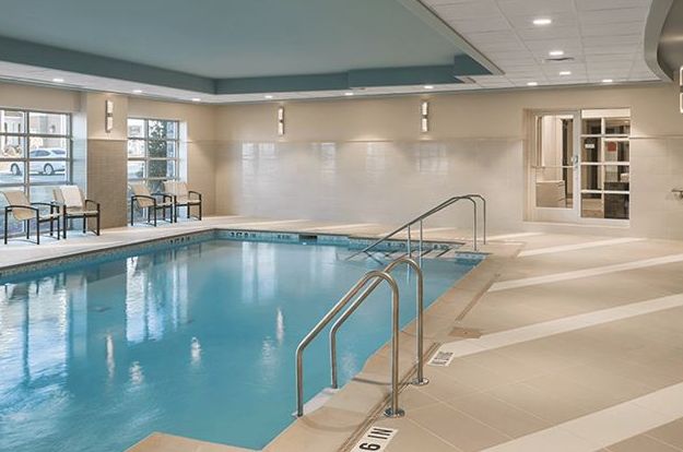 A luxurious indoor swimming pool in a hotel setting.