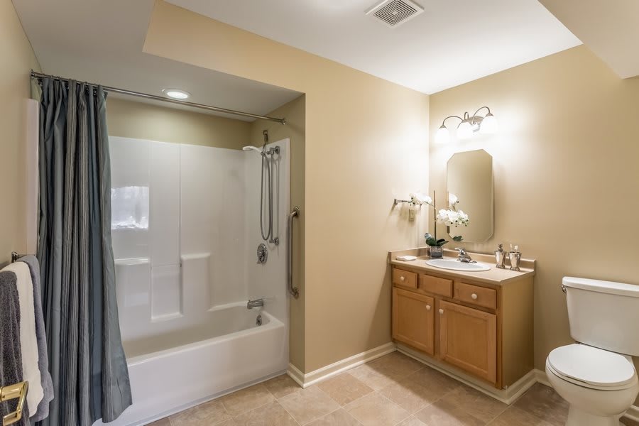 A modern bathroom with a shower-tub combo and a vanity sink.