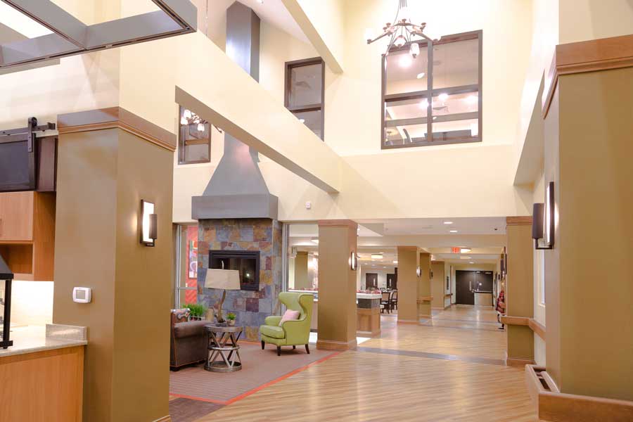 A spacious lobby with comfortable seating, modern decor, and ample natural lighting.