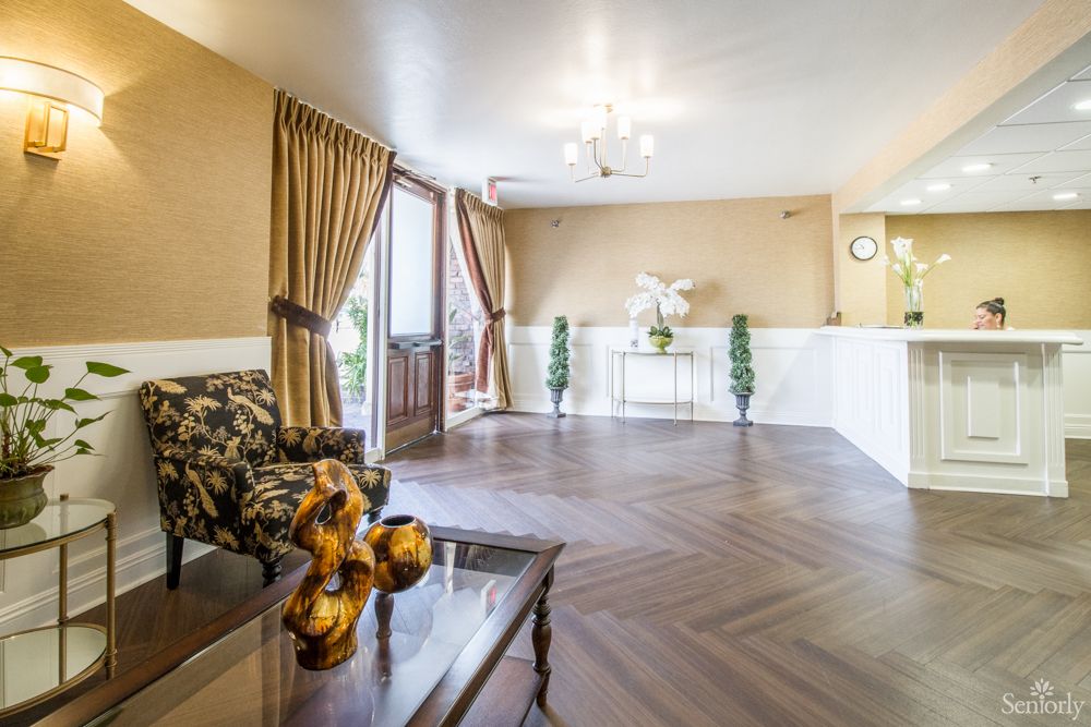 A warmly decorated lobby area with a seating arrangement and decorative accents.