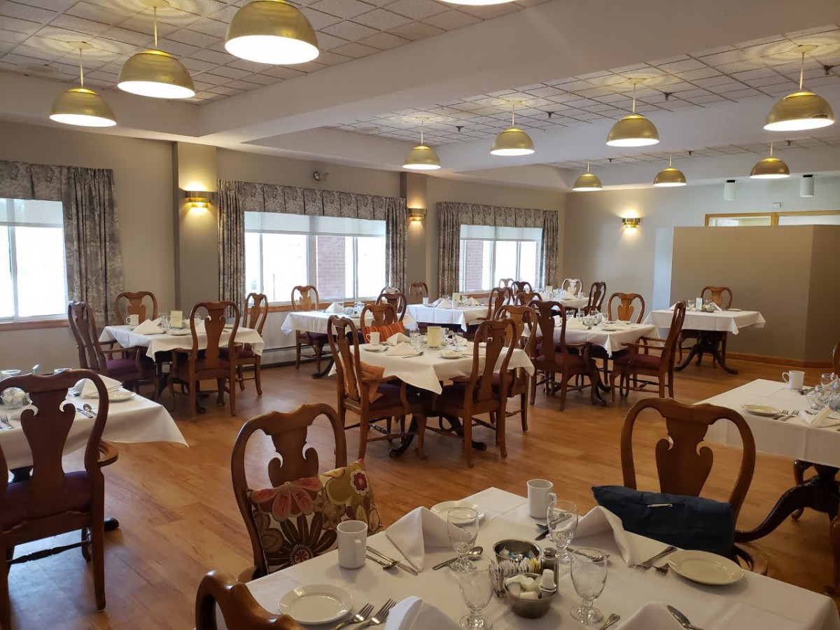 An elegant dining room with neatly arranged tables and chairs, ready for guests.