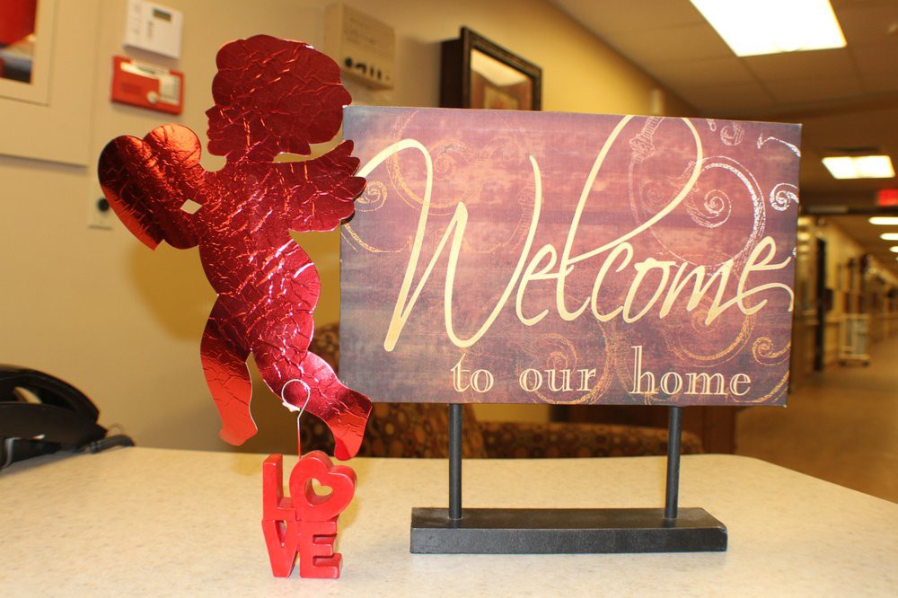 A decorative welcome sign with a red cupid figure, creating a warm and inviting atmosphere.
