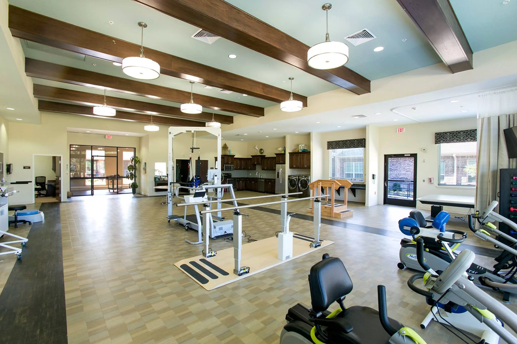 A modern and spacious fitness center equipped with various exercise machines.