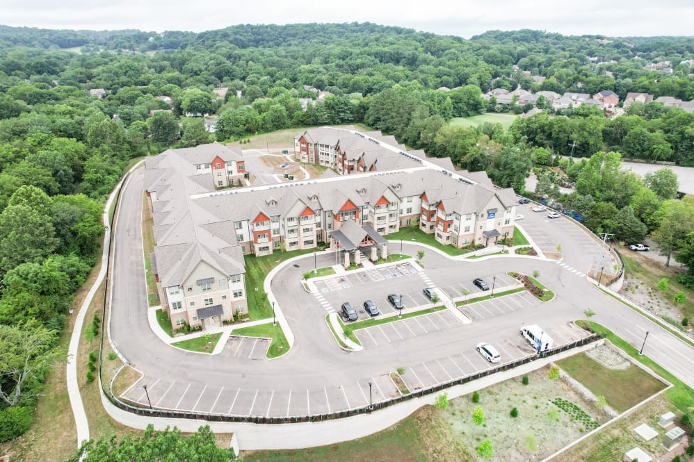 Aerial view of a suburban residential complex surrounded by greenery.