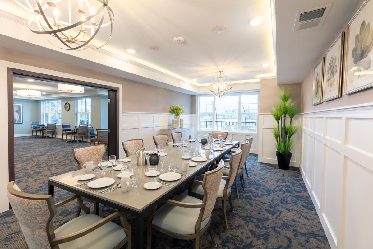 An elegantly decorated dining room with a large table set for a meal.