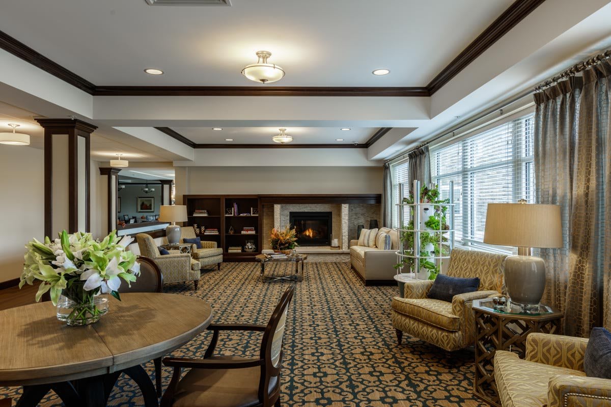 A spacious and cozy living room with elegant furniture and a warm fireplace.