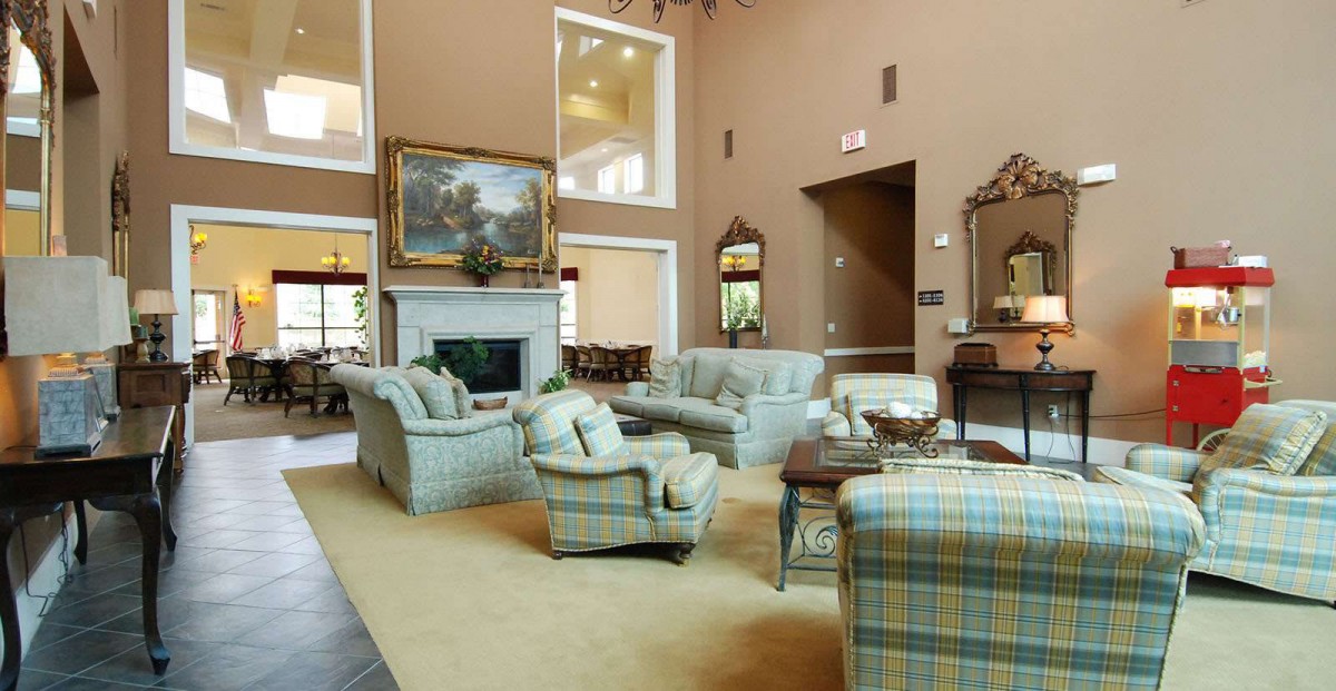 A spacious living room with soft blue seating and elegant decor.