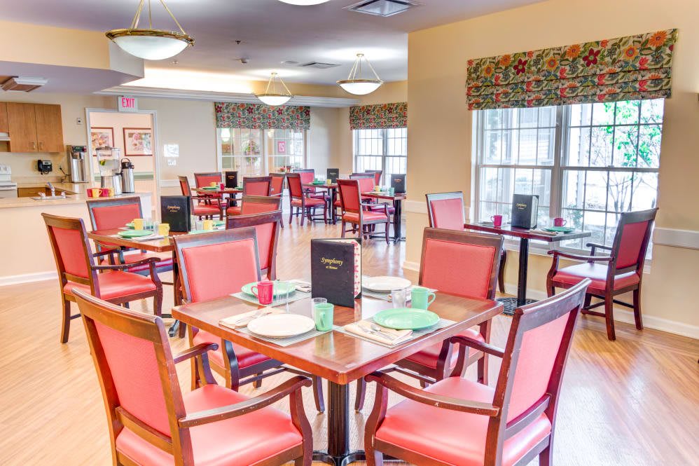 An elegant dining room with neatly set tables and comfortable chairs.