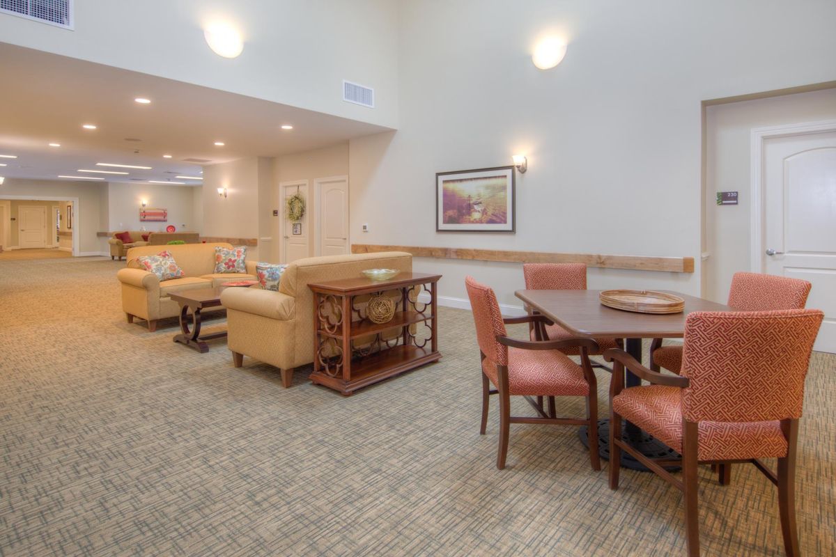 A spacious and comfortable interior featuring a living area and dining set.