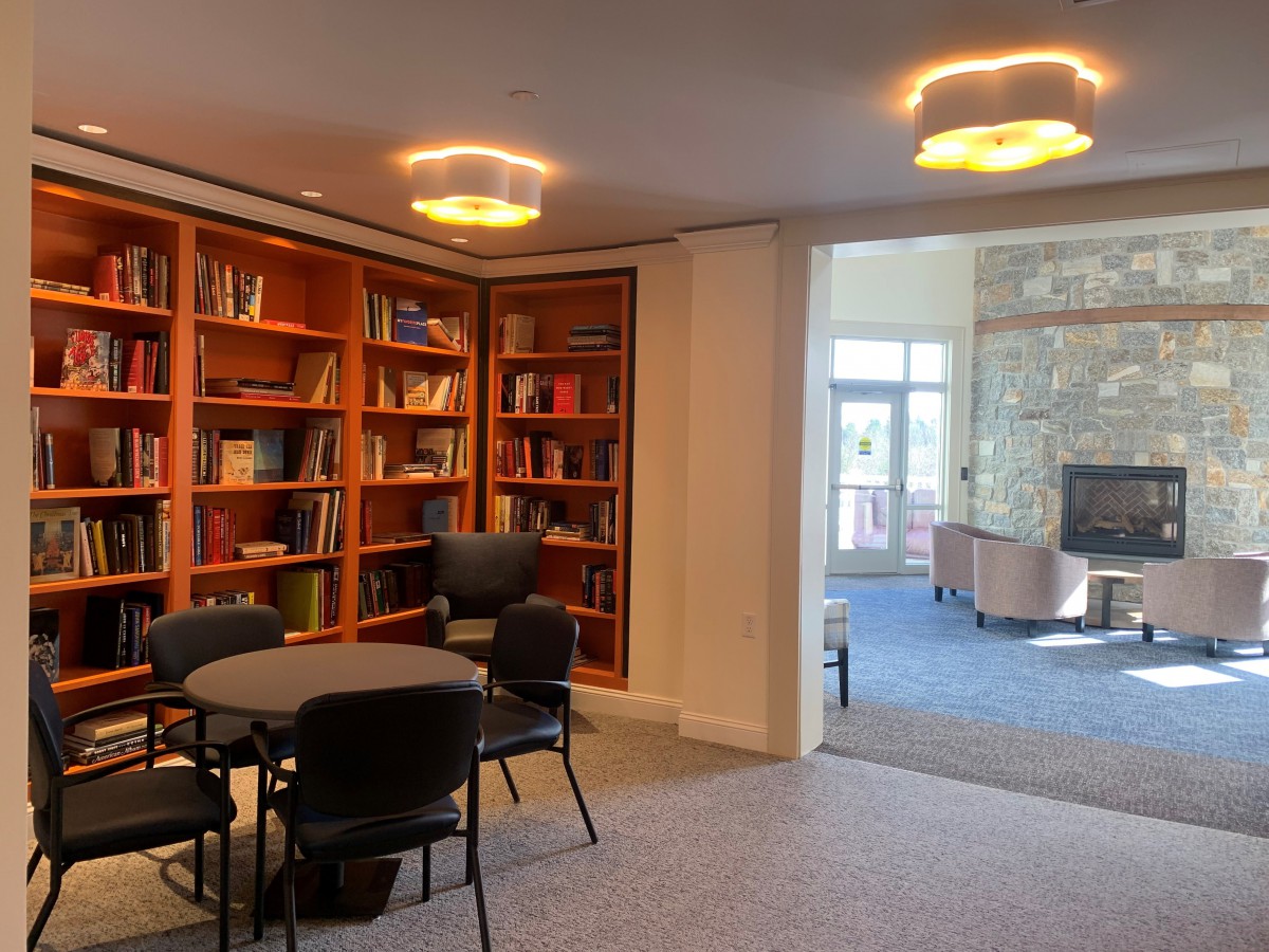 A cozy library corner with bookshelves and a reading area.