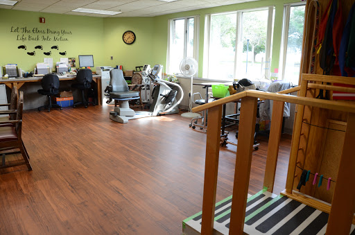 A bright and spacious rehabilitation therapy room equipped with various exercise tools and a welcoming atmosphere.