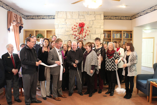 A group of community members gathers for a ribbon-cutting ceremony to celebrate the opening of a new facility.