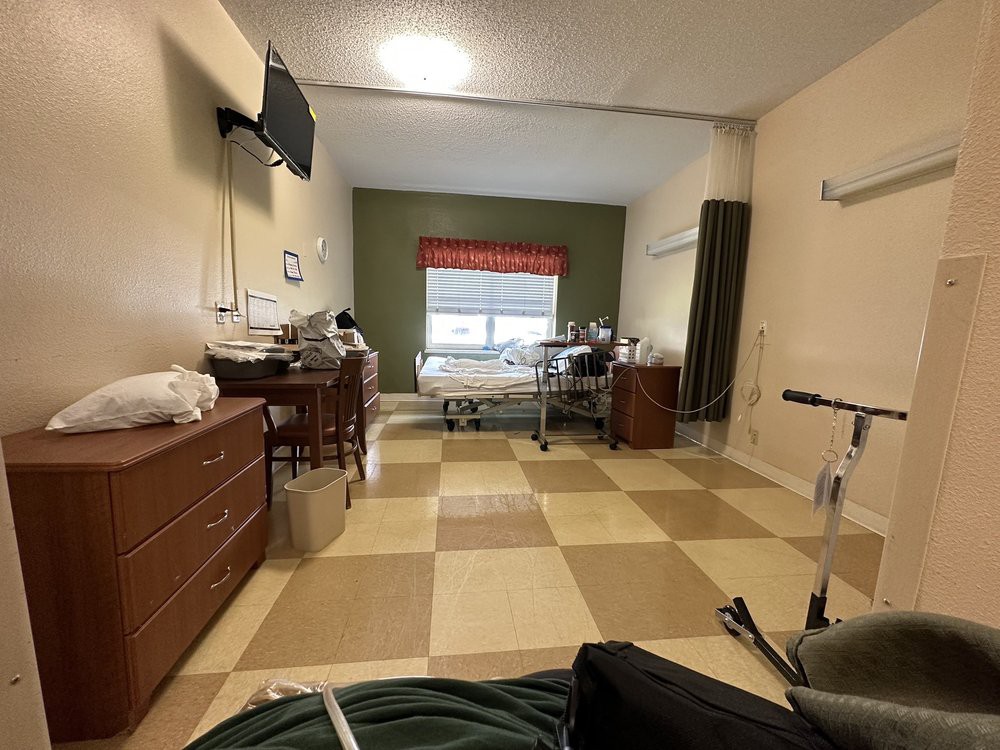 A hospital room with a patient bed and medical equipment.