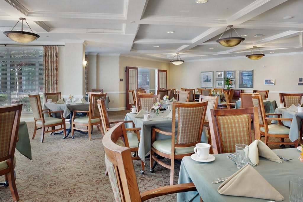 A stylish dining room with neatly arranged tables and chairs.