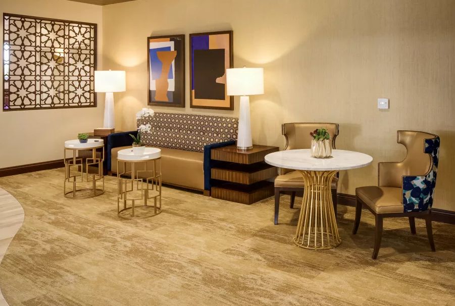 A modern lounge area featuring a comfortable sofa, stylish tables, and elegant lighting.