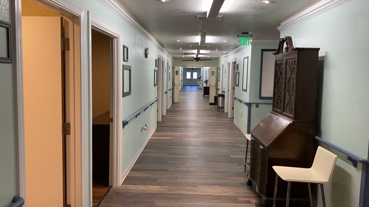 A well-lit hallway with multiple doors and decorative light fixtures.
