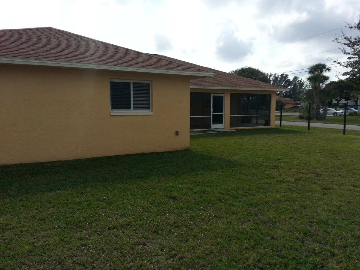 A suburban house with a well-maintained backyard.