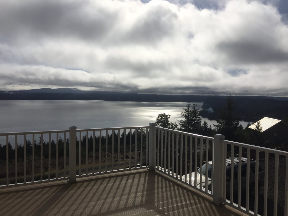 Scenic view of a lake from a deck on a cloudy day.