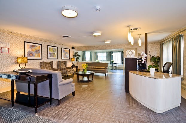 A modern lobby with comfortable seating and a reception desk.
