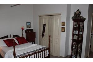 A cozy bedroom with classic furnishings and a neatly made bed.