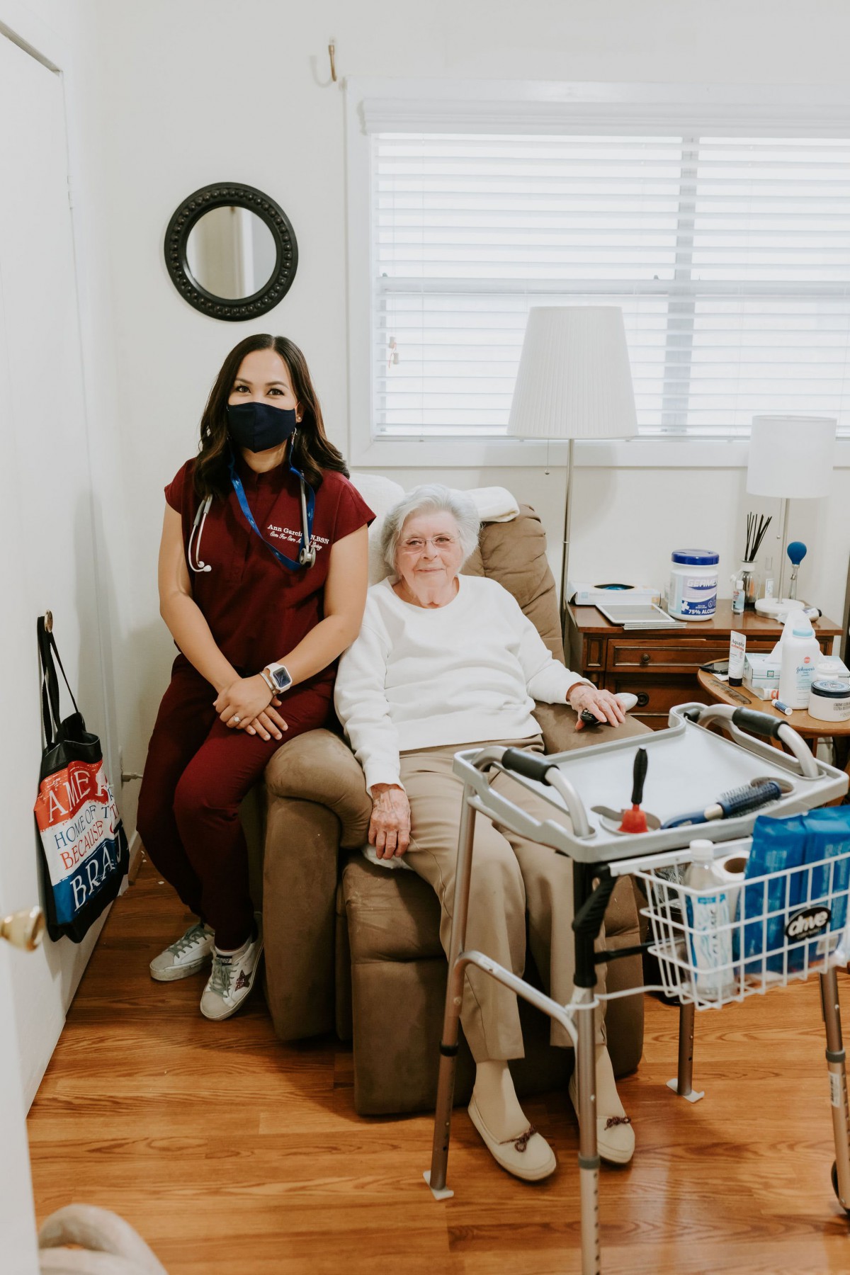 A nurse visits an elderly patient at home, providing care and support.