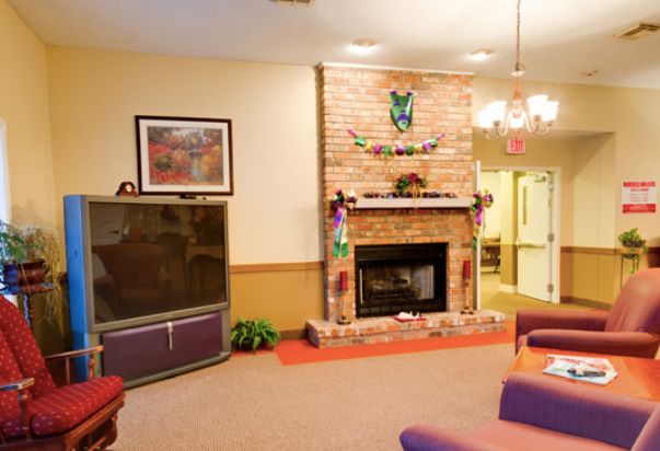 A cozy living room with a brick fireplace and comfortable seating.