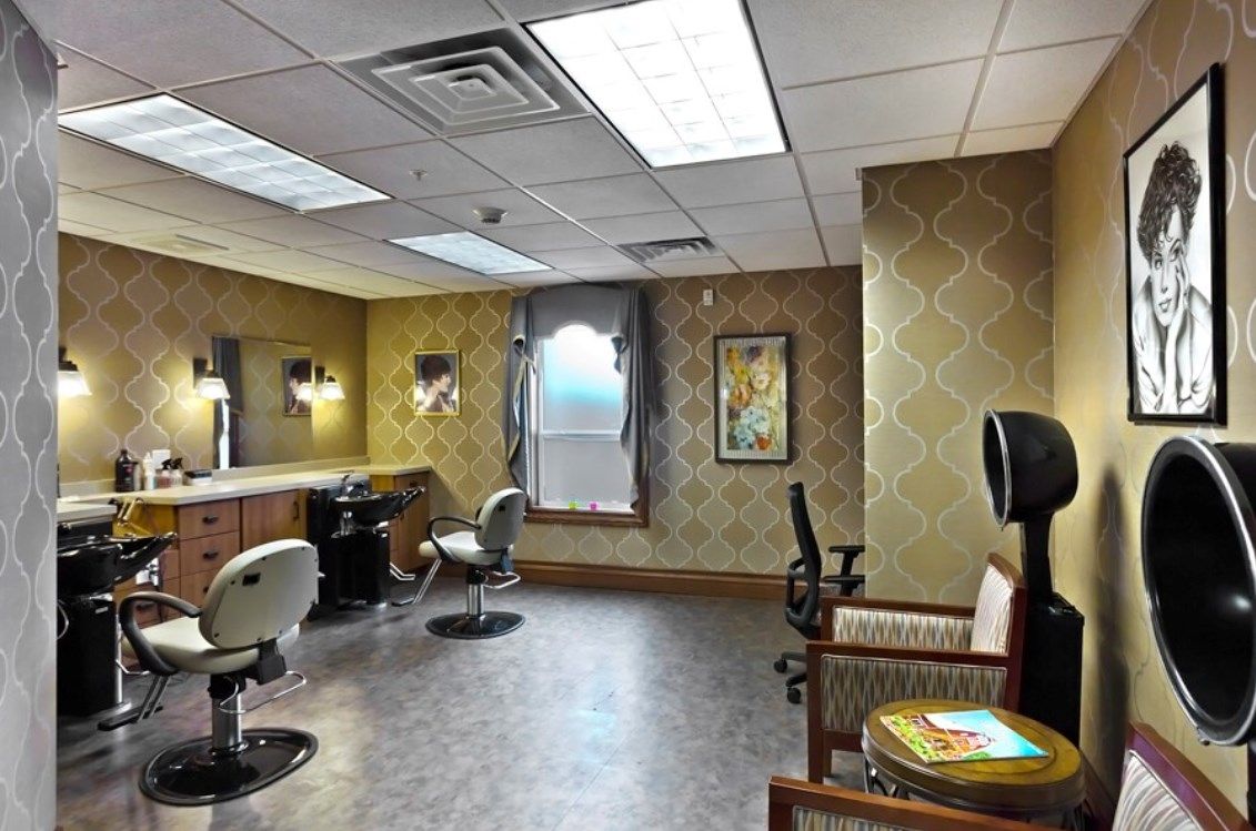 A cozy salon interior with styling chairs, mirrors, and soft lighting.