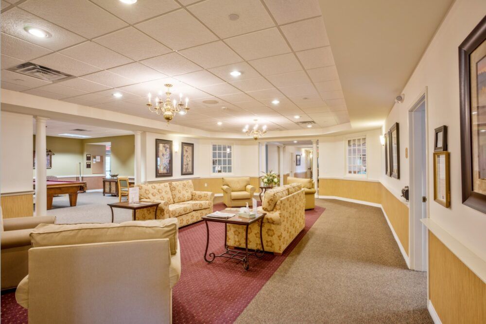 A cozy lounge area with comfortable sofas and a chandelier.