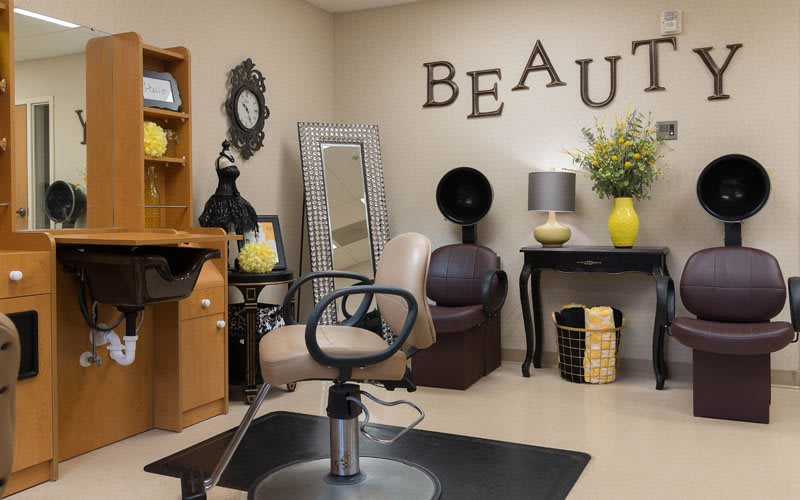 A cozy beauty salon interior with a styling chair, mirrors, and decorative elements.