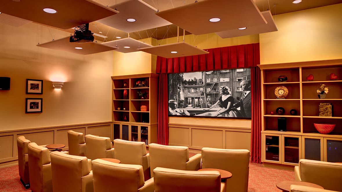 A cozy home theater with comfortable seating and a large screen for movie viewing.