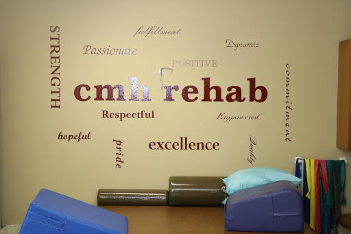 A wall in a rehabilitation center displaying motivational words and the center's name.