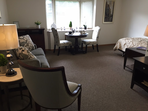 A cozy living space featuring comfortable seating, a small dining table by the window, and tasteful decor.