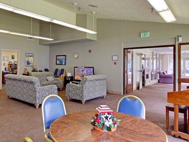 A cozy waiting area with comfortable seating and a decorated table in a communal space.