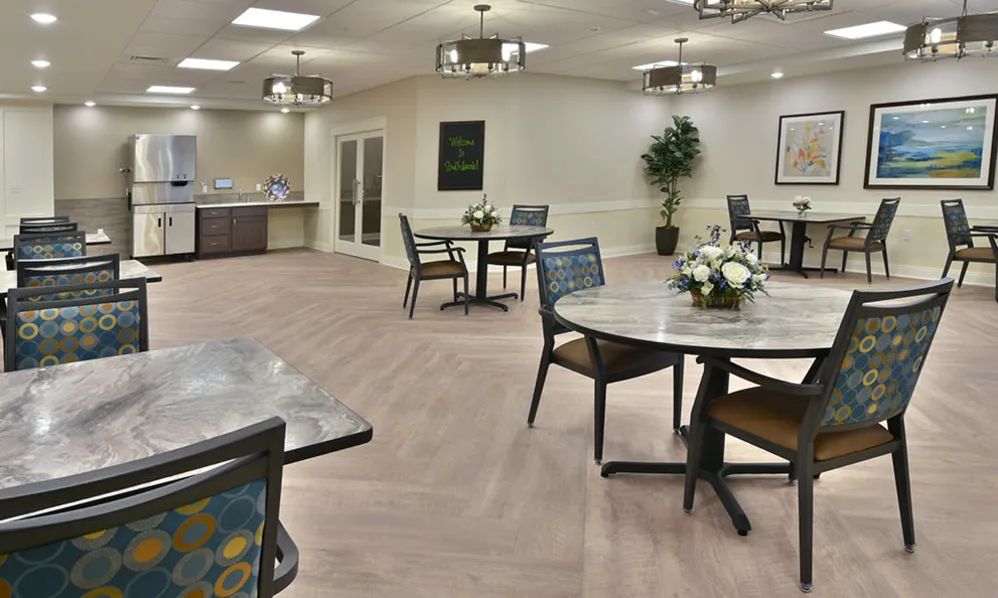 A modern dining area with round tables, chairs, and decorative elements.