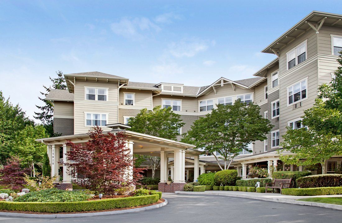 A multi-story residential building with landscaped surroundings.