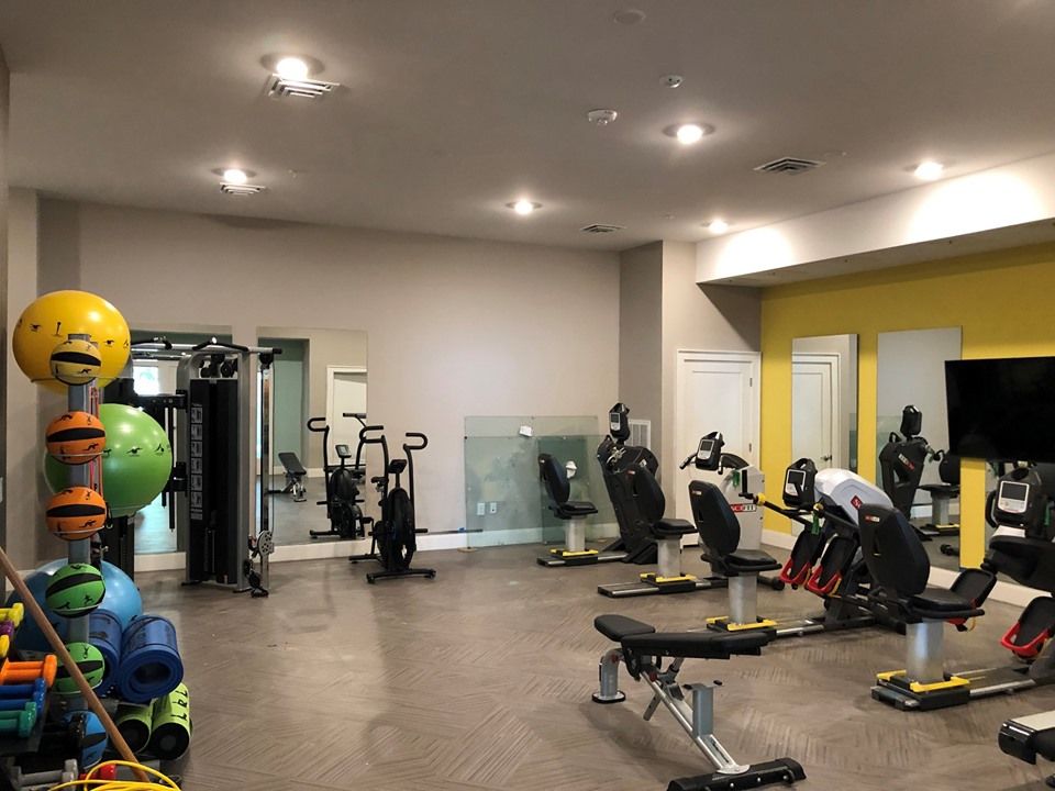 A modern gym with various exercise machines and equipment.