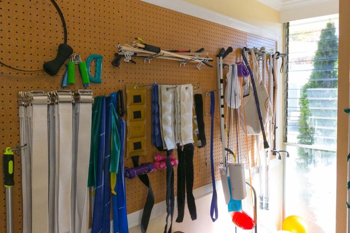 A well-organized pegboard in a garage displaying various tools and equipment.