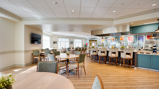 A spacious and modern dining area featuring comfortable seating and a bright atmosphere.