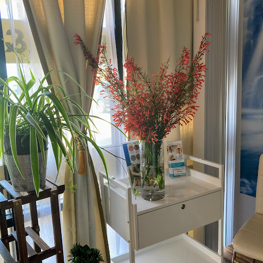 A bright and inviting corner of a room featuring a stylish table adorned with vibrant flowers and greenery.