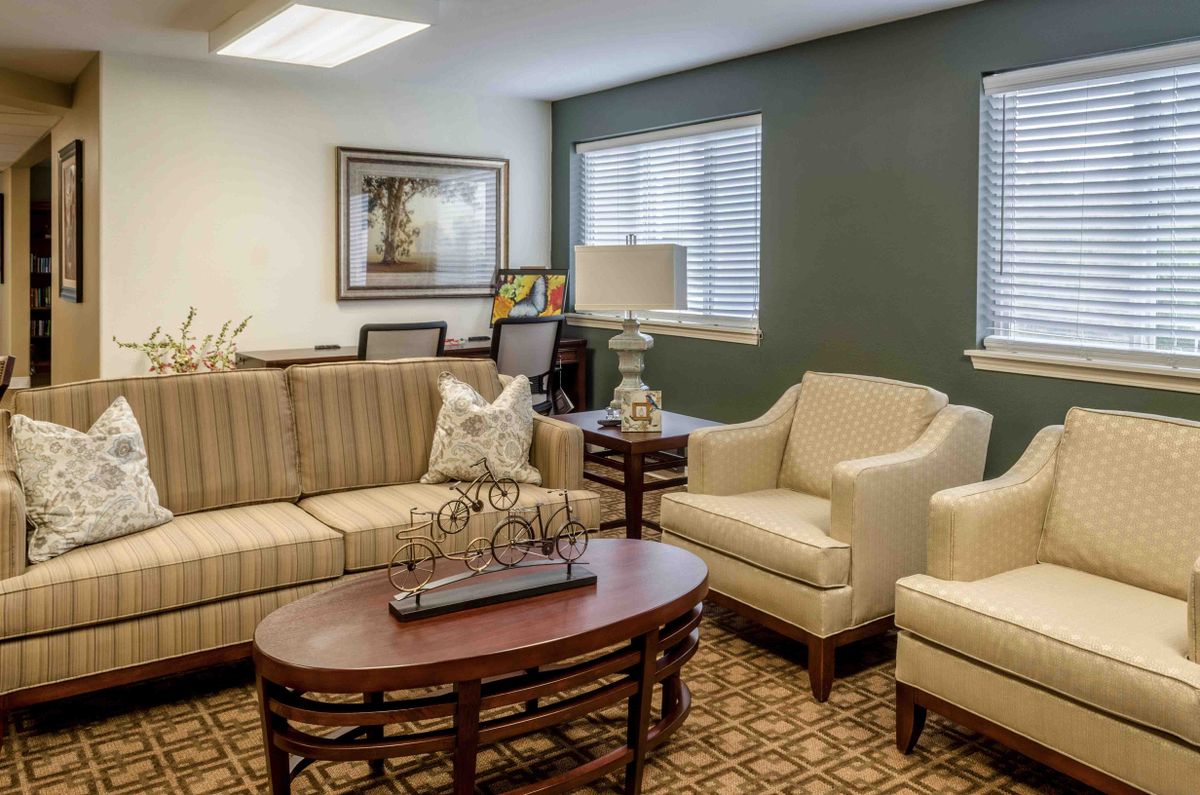 A cozy living room with a sofa, armchairs, and decorative furnishings.
