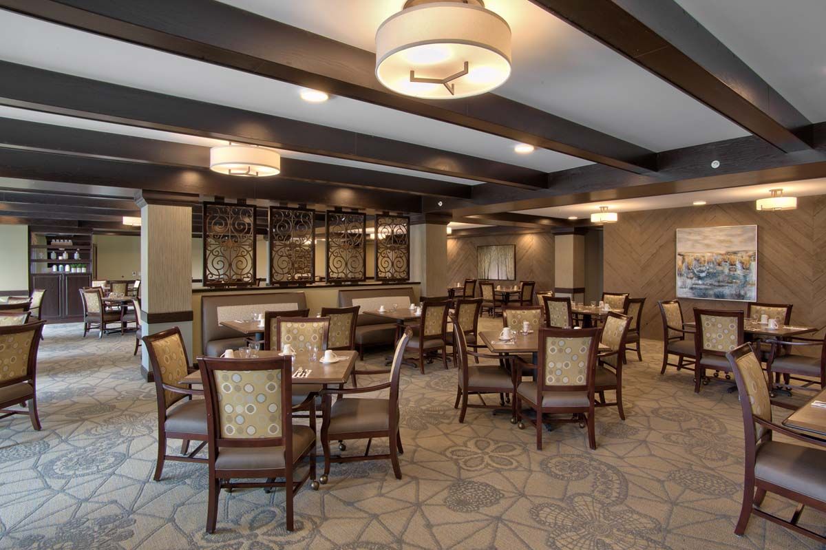 A modern dining room with elegant seating and ambient lighting.