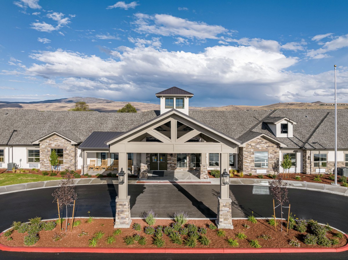 A large residential building with a welcoming entrance and scenic surroundings.